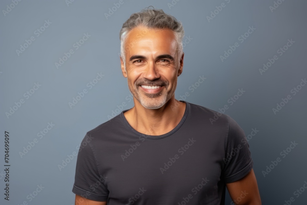 Smiling mature man in black t-shirt over grey background. Smiling mature man in black t-shirt over grey background.
