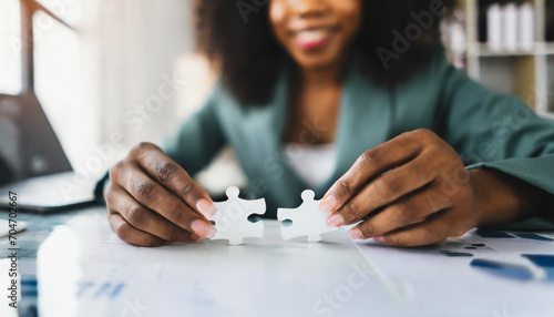 Businesswoman's hand assembles jigsaw puzzle on desk, symbolizing strategy, success, and problem-solving in business photo