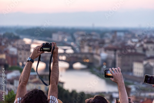 Large tourist crowd on Piazzale Michelangelo enjoying sunset over Florence photo