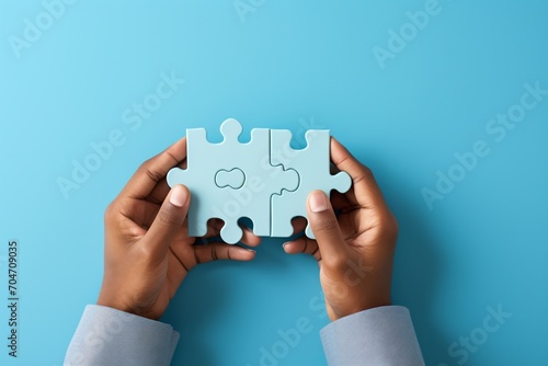Black person holding two puzzle pieces
