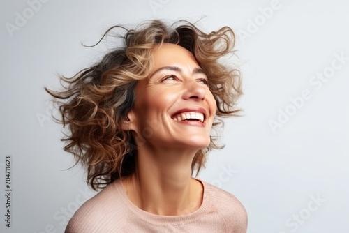 Portrait of a smiling woman with her hair blowing in the wind