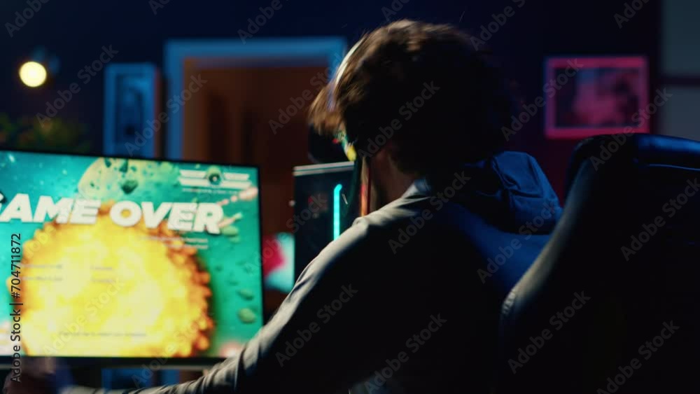 Upset gamer restarting game from beginning after losing mission while playing spaceship videogame. Player feeling disappointed after getting flying spacecraft destroyed by more powerful enemies Upset gamer restarting game from beginning after losing mission while playing spaceship videogame. Player feeling disappointed after getting flying spacecraft destroyed by more powerful enemies