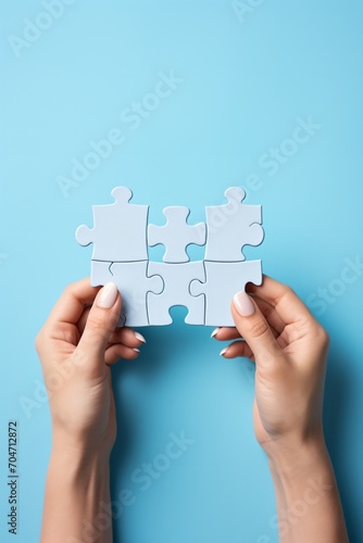 hands holding puzzle pieces to complete the puzzle