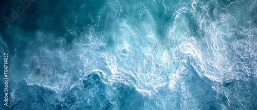 Aerial Perspective of Turbulent Aquamarine Ocean Waves Creating a Textured Marine Tapestry photo