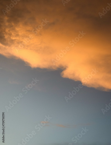 blue sky with a golden sunset over the clouds © LOWE