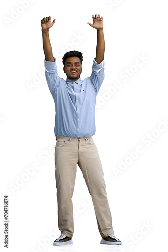 A man in a blue shirt, on a white background, in full height, raises his hands up
