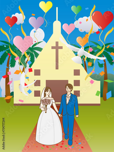 南国の教会の前の小道を祝福されながら歩く新郎新婦