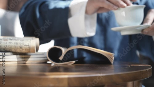 people in ancient costume drinking tea at porch photo