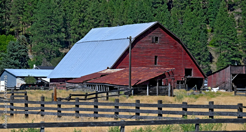 20230813 Old Red Barn with fence and with forest in background 20230813 Old Red Barn with fence and with forest in background
