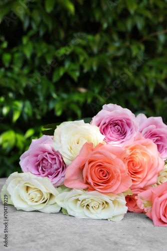 Beautiful bouquet of roses on light grey table outdoors  closeup