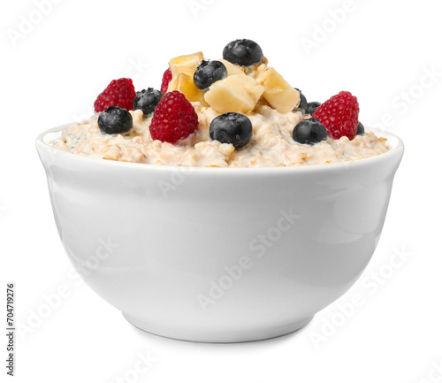 Tasty boiled oatmeal with berries and banana in bowl isolated on white