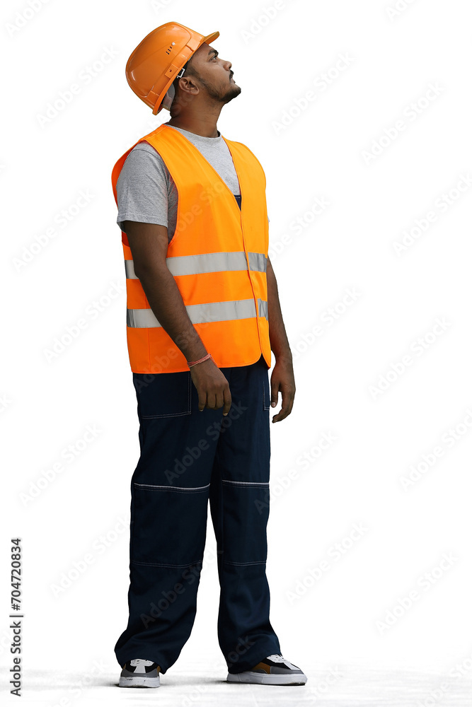 Fototapeta premium A male construction worker, on a white background, in full height, look up