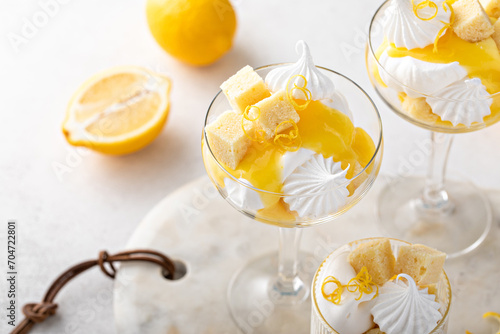 Lemon trifle with pound cake, lemon curd and meringue in coupe glasses photo