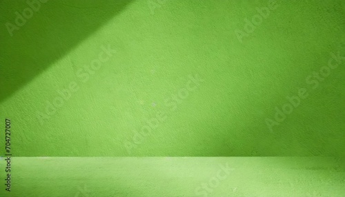 A green wall background with space.