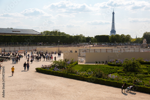 Paris, France - May 20, 2023: view on the Louvre palace and the Tuileries gardens with people
