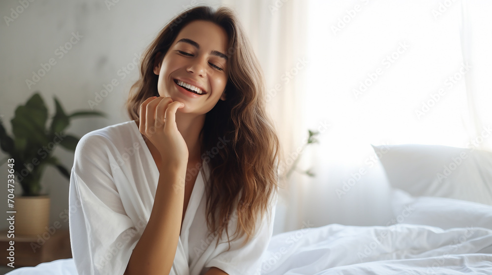 smiling woman applying face cream sitting on bed beauty product - obrazy, fototapety, plakaty 