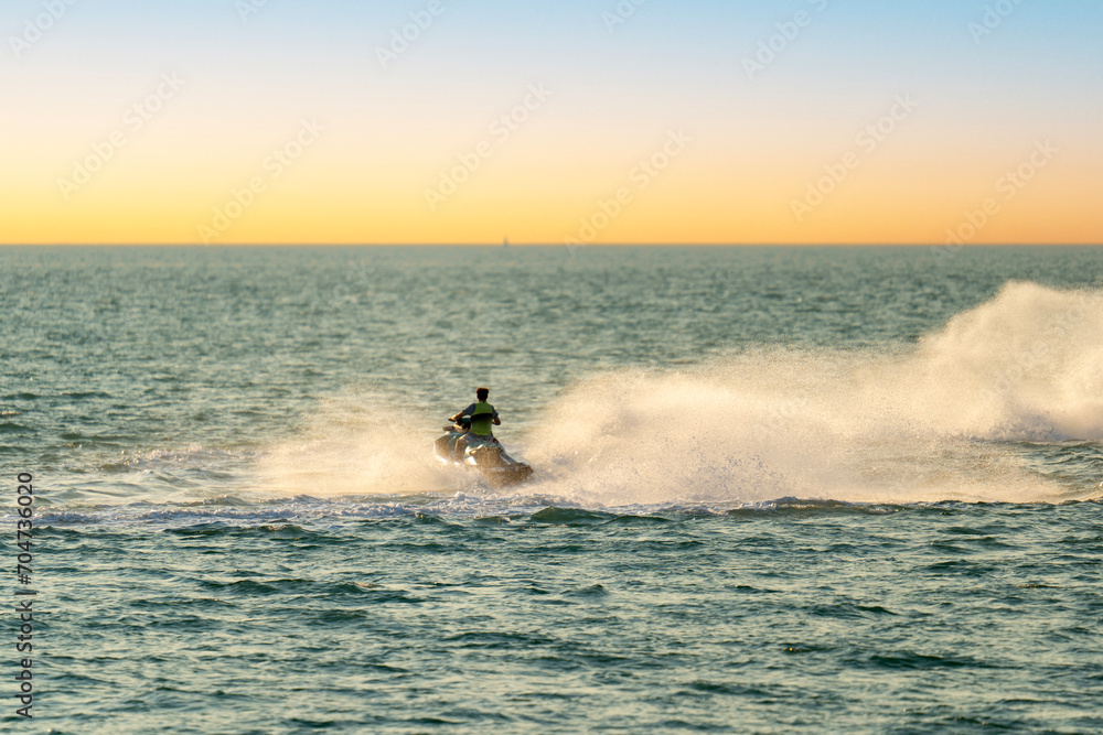 Jet skiing in Darwin harbour at sunset, Northern Territory. Jet skiing in Darwin harbour at sunset, Northern Territory.