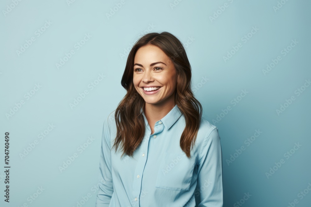 Portrait of a smiling businesswoman looking at camera over blue background Portrait of a smiling businesswoman looking at camera over blue background