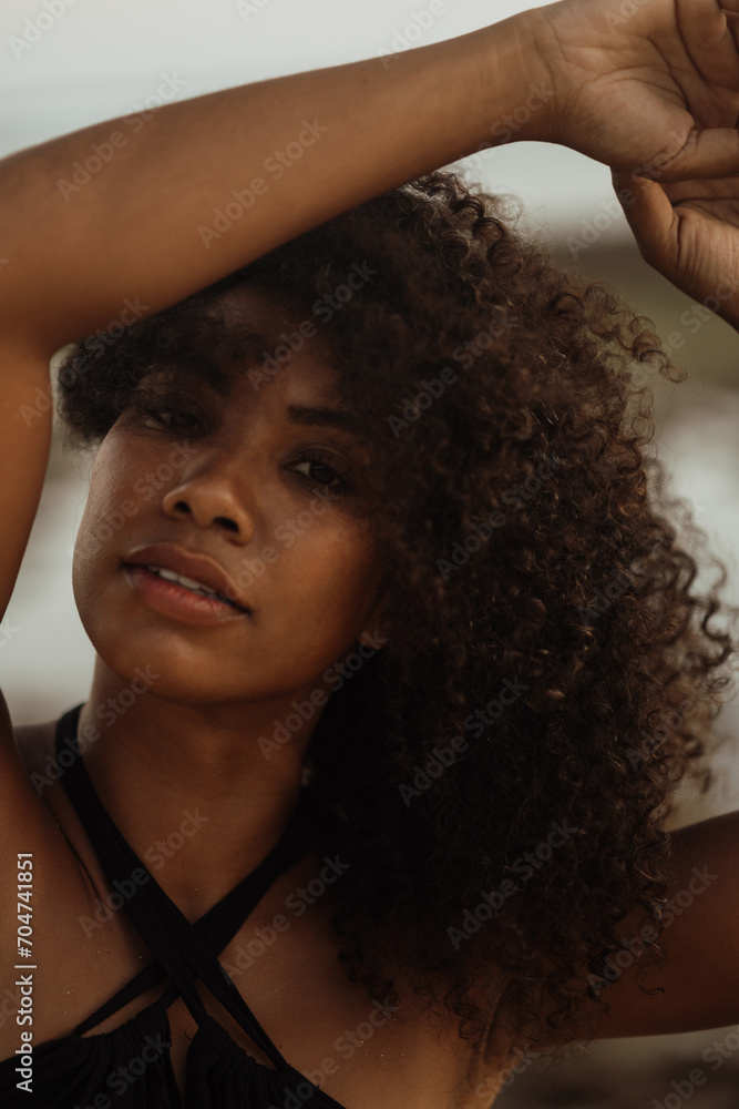African american woman enjoying at the beach with raised hands African american woman enjoying at the beach with raised hands