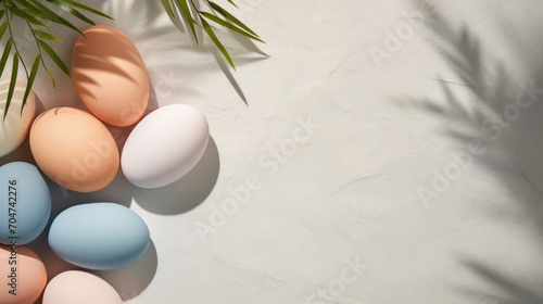 A modern Easter arrangement with pastel eggs and the shadow of palm leaves cast on a smooth, neutral backdrop.