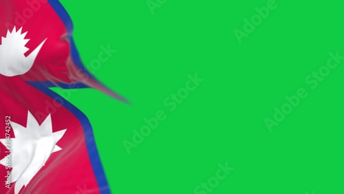 Close-up of Nepal National flag waving in the wind on green screen photo