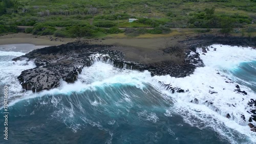 Coast and waves on volcanic rocks on a black sand beach at Reunion Island