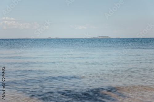 Beautiful blue waves, empty beach during the daytime Clean sand waves of Thailand sunset waterfall landscape Ocean waves crash on the coastal surface of the Gulf of Thailand.