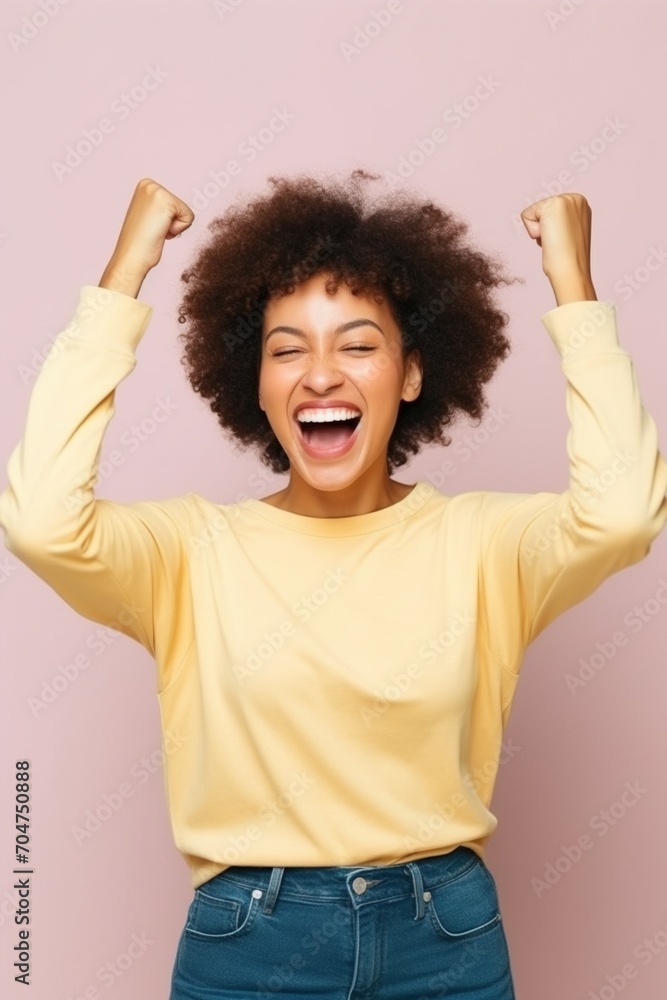 Ecstatic young woman celebrating her success Ecstatic young woman celebrating her success