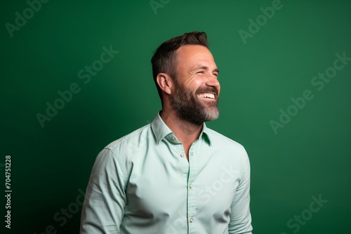Portrait of a handsome man in shirt on a green background.