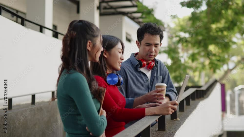 Classmate student friend standing on walkwayand talk about learning content subject in classroom on laptop within university or high school Classmate student friend standing on walkwayand talk about learning content subject in classroom on laptop within university or high school