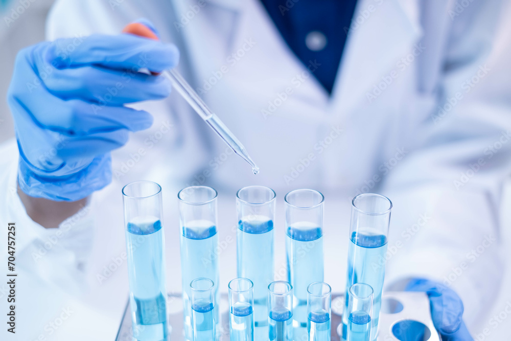 Fototapeta premium Blue glass test tube glassware liquid sample pipette equipment in chemical chemistry biotechnology laboratory science research analysis experiment test industry, scientific pharmaceutical medical