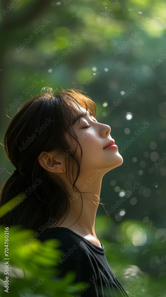 Asian young woman, relax, smile, eyes closed, inhale fresh air, expression air in forest Asian young woman, relax, smile, eyes closed, inhale fresh air, expression air in forest