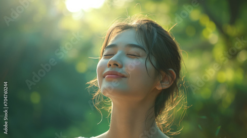 Asian young woman, relax, smile, eyes closed, inhale fresh air, expression air in forest © ND STOCK