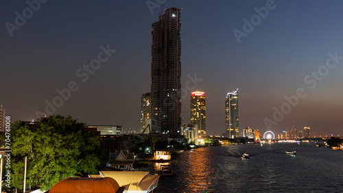 The capital city along the big river in the evening sunset © Thana