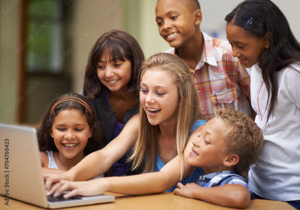 Children, typing on computer and learning in classroom for education, teaching and website information or group project. Happy diversity kids, students and girl with leadership on laptop at school Children, typing on computer and learning in classroom for education, teaching and website information or group project. Happy diversity kids, students and girl with leadership on laptop at school