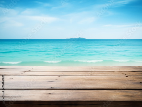 Wooden table with blurred beach and ocean background