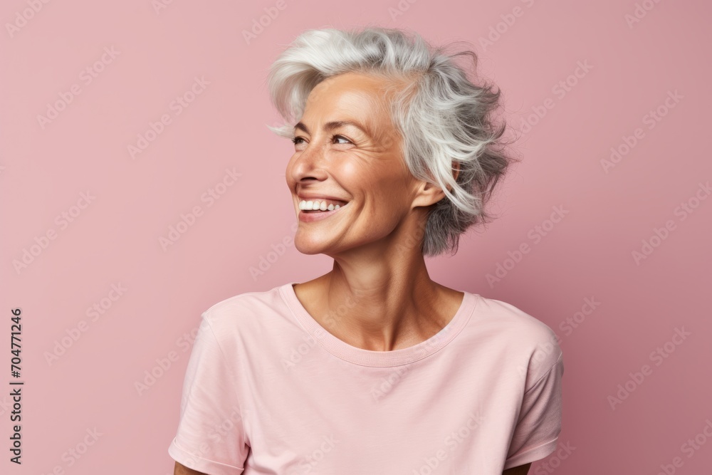 Smiling senior woman with grey hair. Portrait of happy senior woman on pink background. Smiling senior woman with grey hair. Portrait of happy senior woman on pink background.