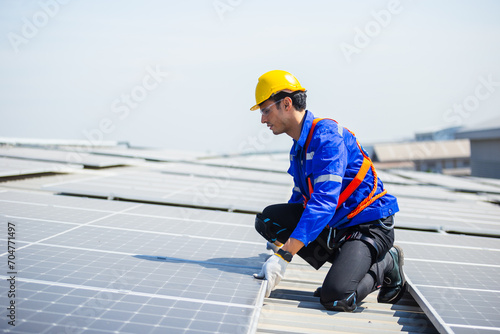Technicians are installing and inspecting standards of solar panels on roof of an industrial factory. Electrical energy obtained from nature sunlight clean renewable energy.