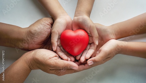 Family hands holding red heart  health care  hope  life insurance concept  world heart day  world health day  adoption foster care home  organ donor day  csr social responsibility  gratitude