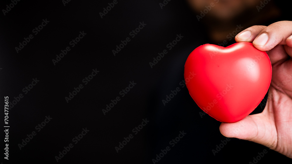 Red heart in man hands. Healthcare concept, organ donation concept. Symbolic of Valentine day. Heart day with copy space. Red heart in man hands. Healthcare concept, organ donation concept. Symbolic of Valentine day. Heart day with copy space.