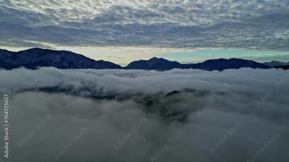Clouds gather beneath the mountain peaks Clouds gather beneath the mountain peaks