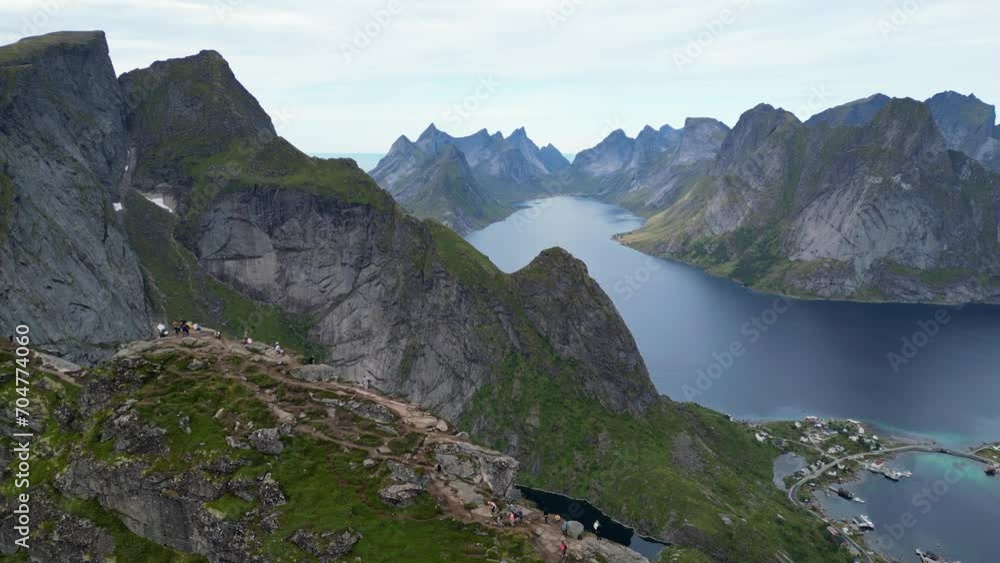 Reinebringen Hike in Lofoten Islands, Norway - Aerial View of People enjoy View on Top of the Mountain Reinebringen Hike in Lofoten Islands, Norway - Aerial View of People enjoy View on Top of the Mountain