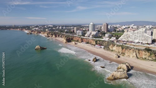 Establishing aerial of beautiful long beach of praia dos Tres Castelos in Portimao photo