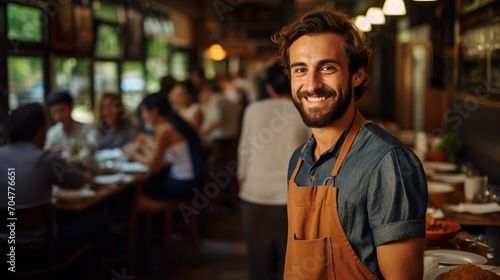 Bearded waiter wearing apron in restaurant