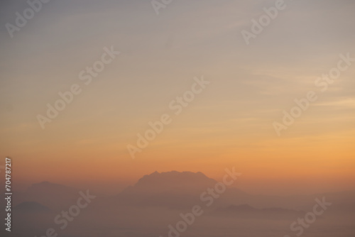 travel and people activity concept with twilight sky before sunrise with mountain and fog on foreground