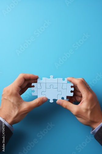 Wallpaper Mural Businessman connecting puzzle pieces to complete the puzzle Torontodigital.ca