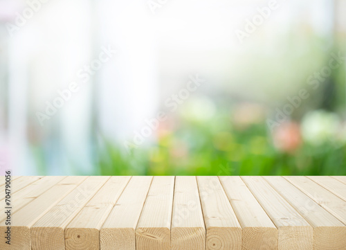 Selective focus.Wood table counter on blur flower garden background.