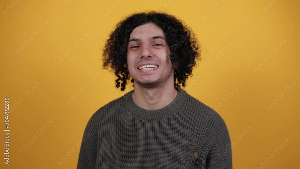 Smiling friendly charming cheerful fun young man laughing against yellow background. People lifestyle concept. Smiling friendly charming cheerful fun young man laughing against yellow background. People lifestyle concept.