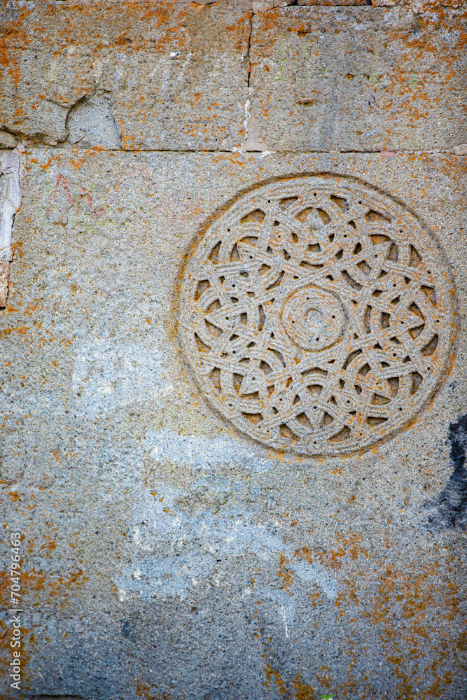 Vintage ancient pattern decoration on the wall of a stone Georgian church.