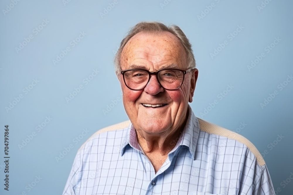 Portrait of a smiling senior man with glasses on a blue background Portrait of a smiling senior man with glasses on a blue background